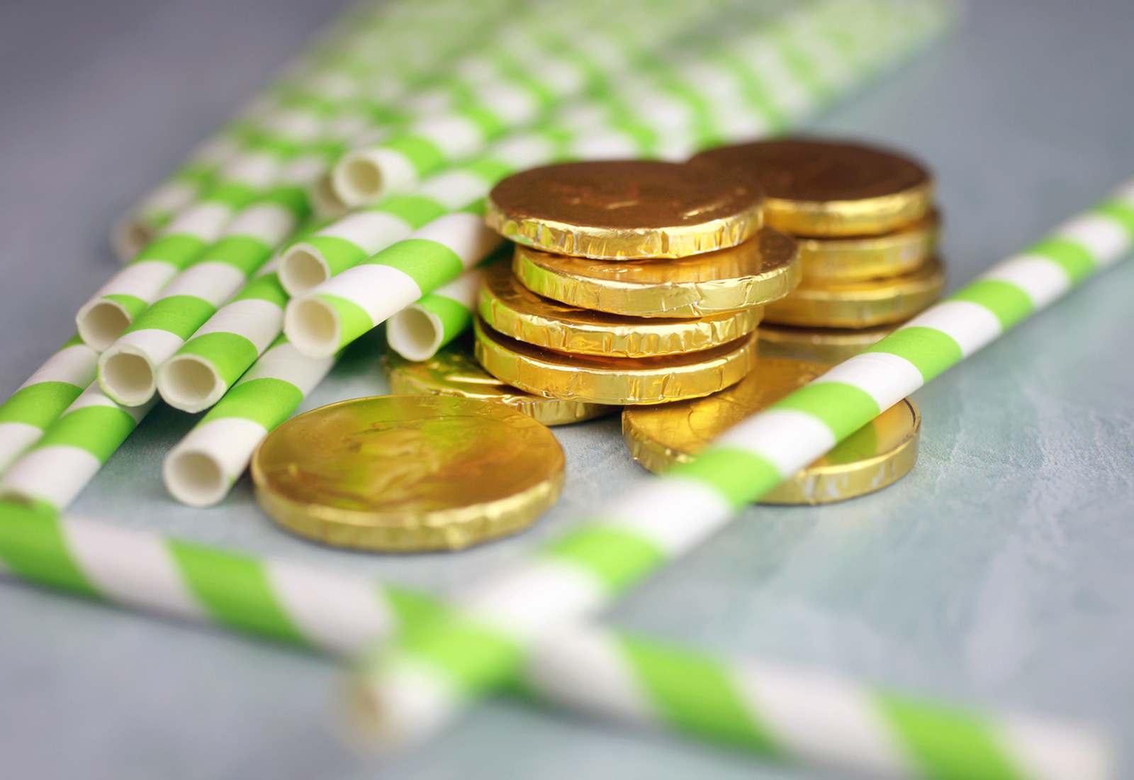 Green striped paper straws and chocolate coins